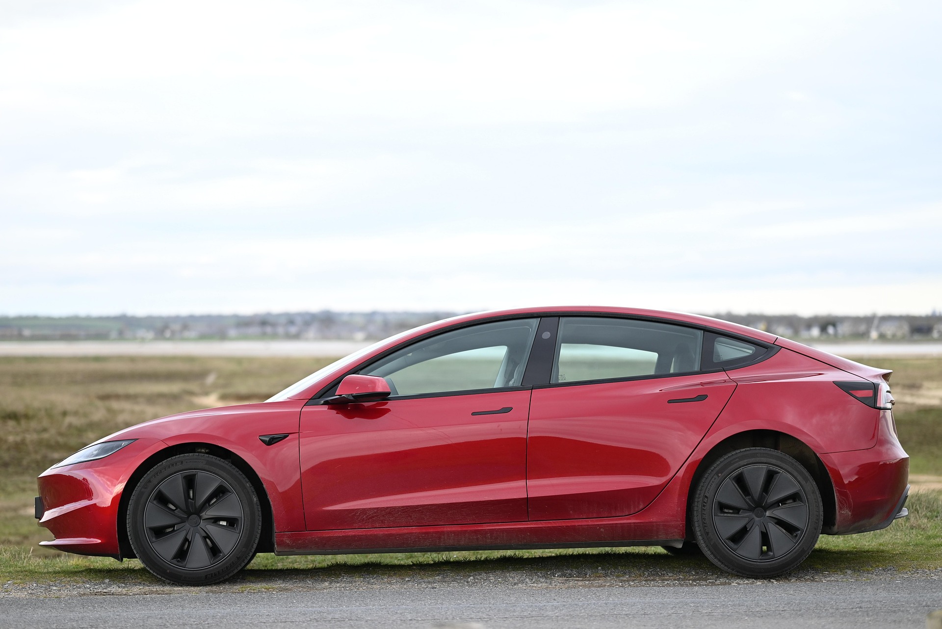 A modern sedan parked in a clean city environment representing safety and insurance
