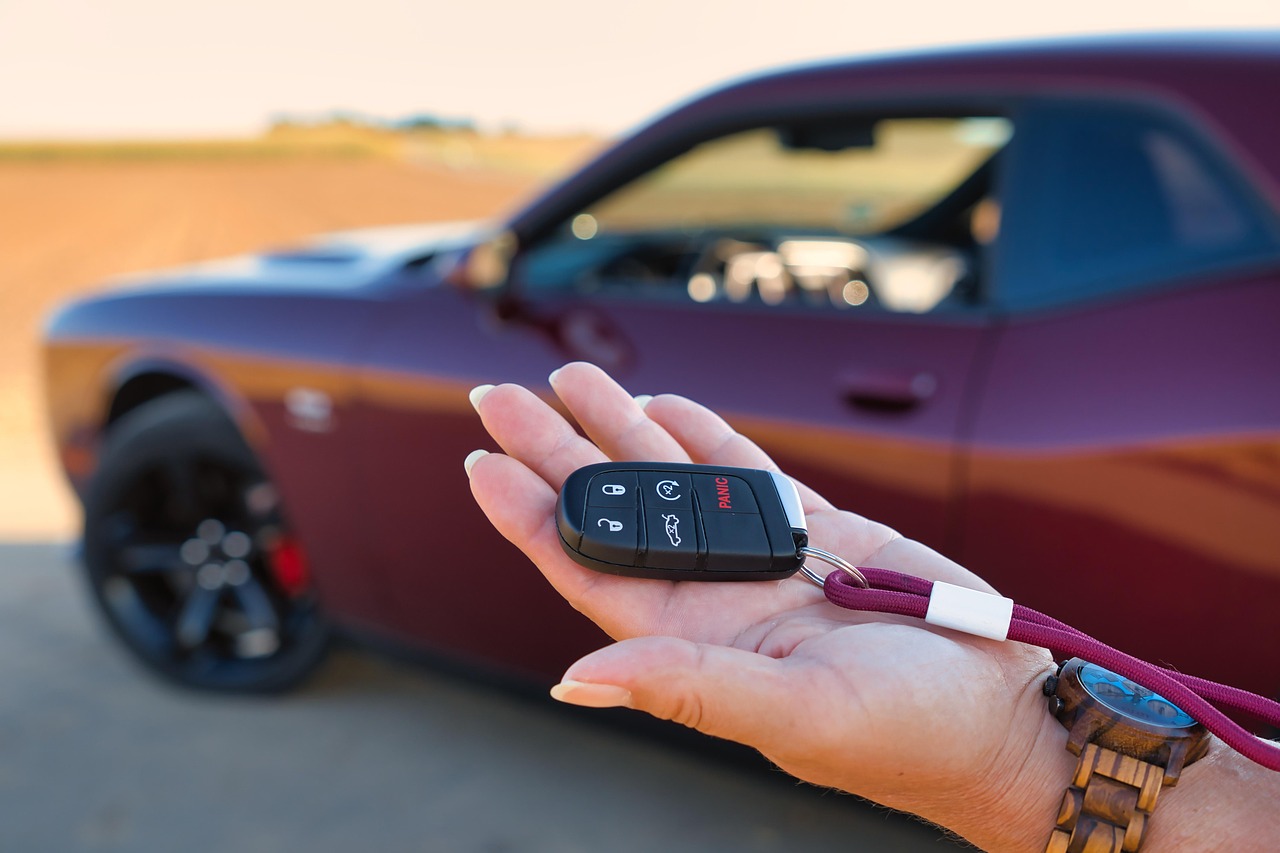 A friendly insurance agent handing car keys to a satisfied customer